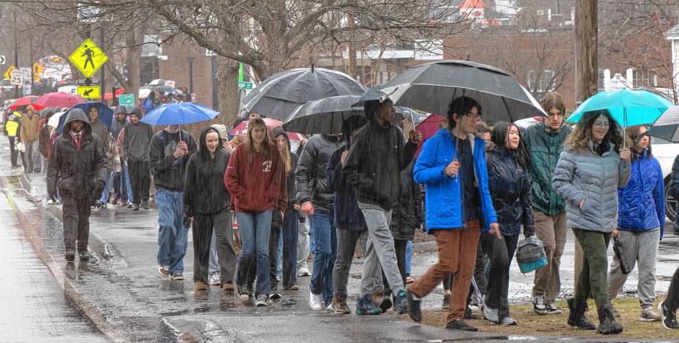 Amherst Regional High School and Amherst Middle School students walk back from the UMass Campus Center after protesting at a hearing of the Joint Committee on Ways and Means  Monday morning. 