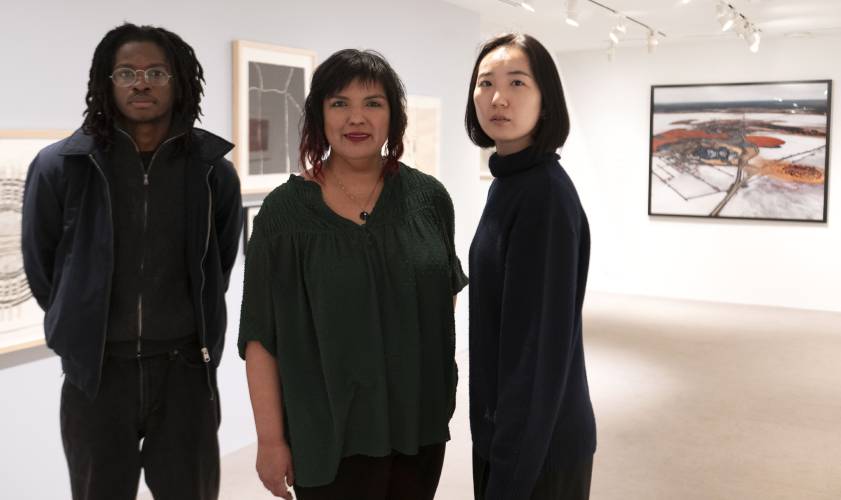 From left, Adeyemi Adebayo, Eva Barajas and Bo Kim, curators of the show “(Off)Balance: Art in the Age of Human Impact,” at the University Museum of Contemporary Art at UMass Amherst.