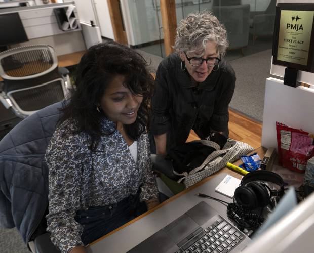 Jill Kaufman, a reporter with New England Public Media, edits a story with Nirvani Williams in Springfield on Wednesday.