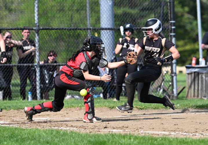 Pioneer’s Greta Lewis scores as Athol catcher Madi Hermes mishandles the throw in Northfield on Tuesday.  