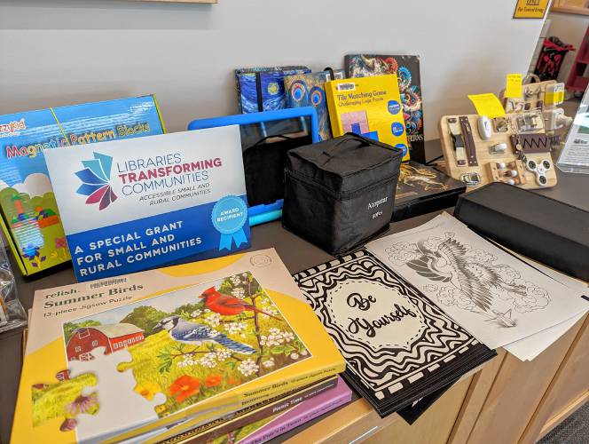 Some Erving Public Library materials that were purchased with the “Libraries Transforming Communities” grant funds that patrons can use in the library and borrow to take home. There are fidget boards for adults, puzzles for a range of abilities, different kinds of coloring sheets, tablets and more.