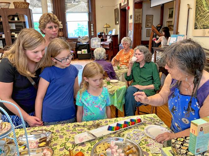 The Shelburne Historical Society hosted its “Summer Sweetheart Tea Party” in honor of Alice Brown’s Sweetheart Tea Room on June 23. Attendees were able to enjoy a cup of English tea served with traditional English sweets. Pictured, from left, are Tarah Perna and her daughters Olivia, 10, and Mia, 7. Perna’s mother, Helen Fain, is pictured standing behind them. Reba-Jean Shaw-Pichette of the Shelburne Historical Society is pictured at right.