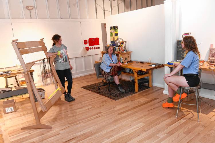 Anna Slezak, Kiah Tinkham and Elende Connor in their workspace at Waterway Arts in Turners Falls. 