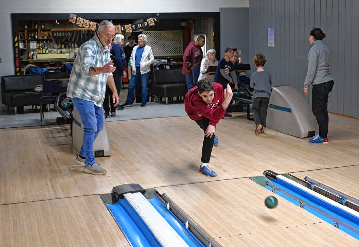 Robert Vecchio gives pointers to his grandson Caiden Vecchio, 13, as he bowls at the French King Bowling Center in Erving.