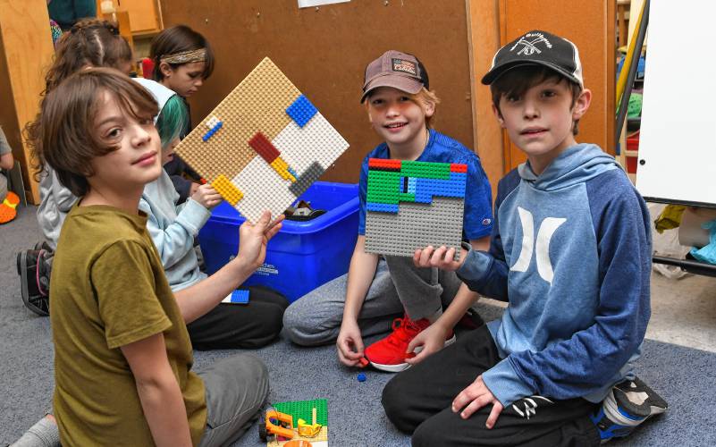 Conway Grammar School fourth grade students Max Craig, Wyatt Burt and Miles Williams use LEGOs to make designs in the style of Piet Mondrian (1872-1944), a famous painter who used blocks of color.  Several Activities throughout the school on Tuesday were aimed at recognizing the relationship between math, art and music.