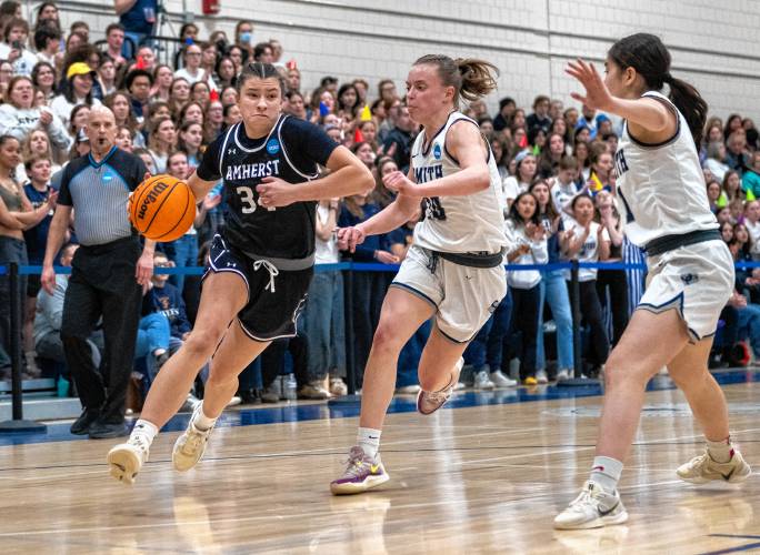 Amherst guard Macie Nugent, left, dribbles around Smith guard Maggie Fleming, right, during the NCAA Division 3 Women's Basketball tournament Round of 32 game at Ainsworth Gym, Saturday.