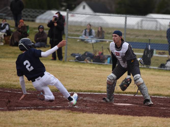 Frontier Regional’s Carter Miller (2) slides safely into home to score a run for the Redhawks during their game with Hopkins on Wednesday afternoon in Hadley.