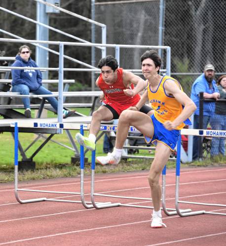 Frontier’s Ben Cachiguango and Mohawk Trail’s Chay Mojalali compete in the 110 hurdles during a meet in Buckland on Monday. 