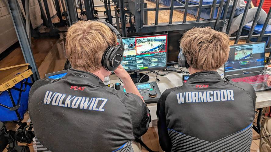 Tyler Wolkowicz and Izac Wormgoor at work producing a basketball game while working for Frontier Community Access Television.