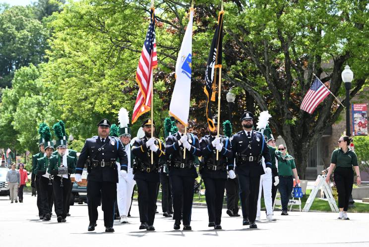 The Greenfield Police Department Color Guard precedes the Greenfield High School Marching Band down Main Street during Memorial Day activities in Greenfield Monday.