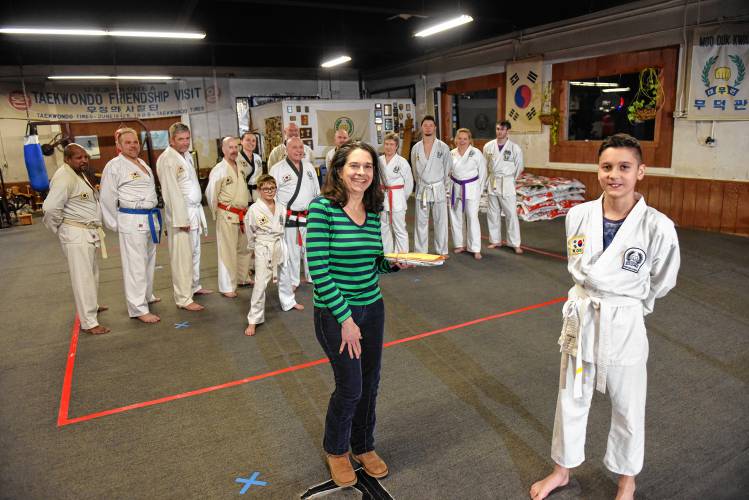 Patti Wasilewski of the Greenfield Recorder accepts a donation from Natan Volosenco, 12, from the Greenfield Tae Kwon Do Center. The Federal Street center holds a “break-athon” fundraiser each year to benefit Warm the Children, the Greenfield Recorder’s charity that helps provide warm clothing for families in need across Franklin County and the North Quabbin region. The 21st annual “break-athon,” held in November, raised $6,308 for the charity.