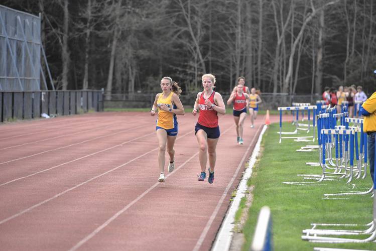 Mohawk Trail’s Virginia Krezmien and Frontier’s Leah Gump pace the field during the mile on Monday in Buckland. 