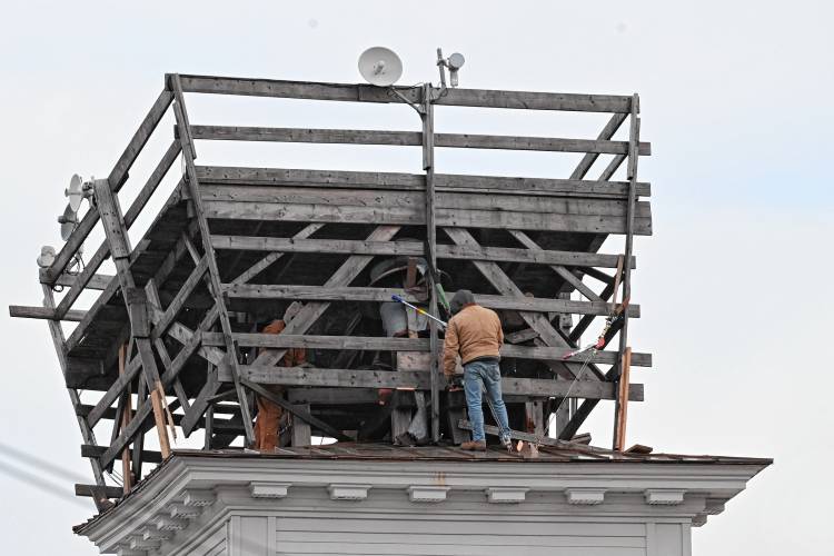 Workers atop Ashfield Town Hall, where the temporary structure shifted amid heavy winds.