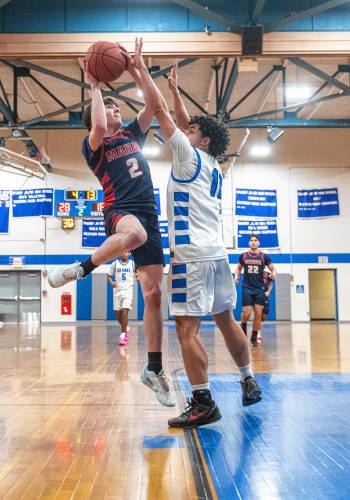 Mahar's Morgan Softic (2) attempts a shot over Granby's Raymond D. Colon (11) during the PVIAC Class C tournament semifinal game Tuesday in Granby.