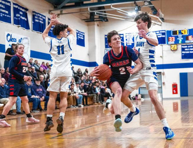 Mahar's Morgan Softic (2) attempts to dribble around Granby's Riley Goodhind (1) during the PVIAC Class C tournament semifinal game Tuesday in Granby.