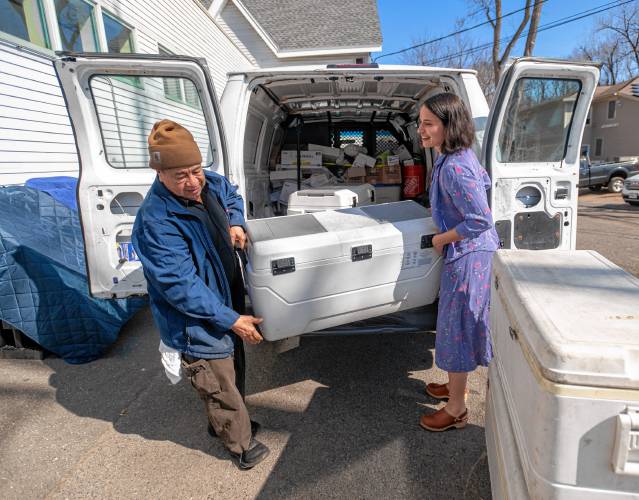 La Veracruzana employee Modesto Garcia, left, and Northampton Survival Center Program Coordinator Kilee Mercedes unload a cooler full of pre-made meals at the Survival Center. The Survival Center is partnering with La Veracruzana and Uya Poke Bowl to provide more than 2,800 meals.