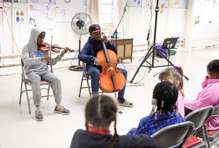 Oluwashina Adeyemi, 12, and Guemson Laguste, 13, play a French folk song at Musica Franklin’s talent show at the First United Methodist Church in Greenfield on Thursday evening.