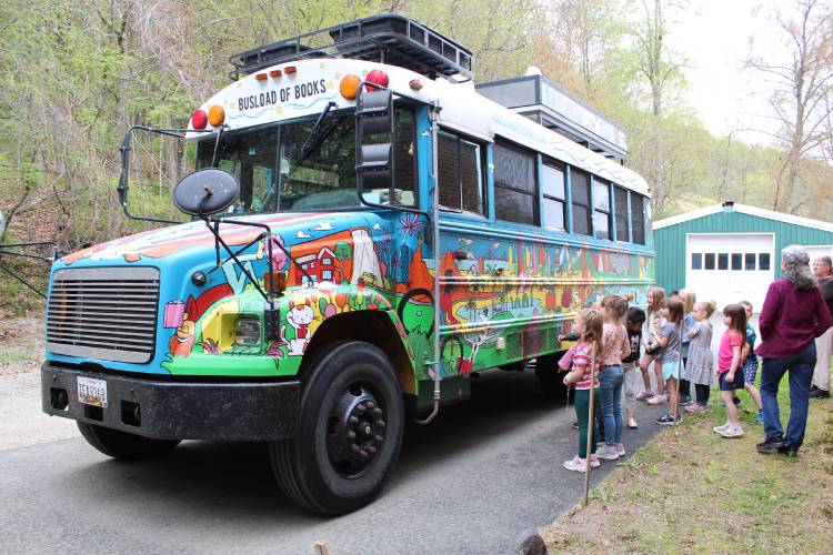 Colrain Central School students play “I Spy” with a mural painted on a school bus that was converted into the mobile home and library of the husband and wife author/illustrator team of Matthew Swanson and Robbi Behr.