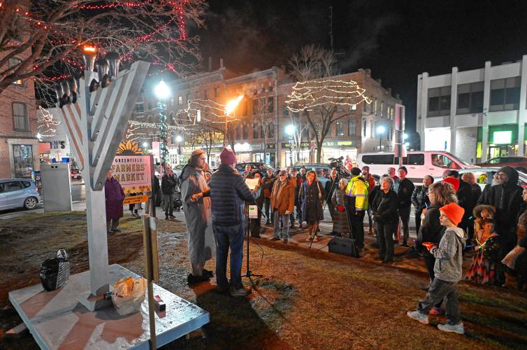 Greenfield Board of Assessors Chair Jim Geisman speaks before lighting the menorah on the Greenfield Common with Jasper Lapienski on the sixth day of Hanukkah on Monday.