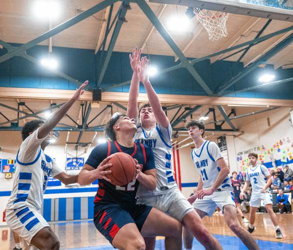 Mahar's Jayden Delgado, center, looks to attempt a shot over Granby's Sawyer Clarke, right, during the PVIAC Class C tournament semifinal game at Granby High School, Tuesday.