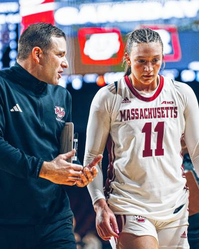 UMass women’s basketball head coach Mike Leflar (left) talks to junior Megan Olbrys (right) as they walk to the locker room at halftime of the Minutewomen’s 42-40 loss to Rhode Island on Sunday afternoon in Amherst.