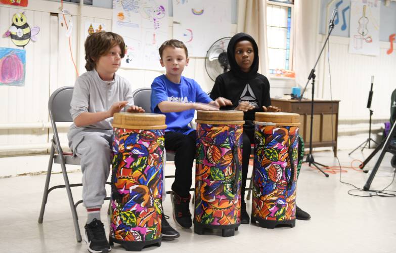 Andrew Ramsey, 9, Ryker Blier, 10, and Marcus Mitchell, 9, play drums at Musica Franklin’s talent show at the First United Methodist Church in Greenfield on Thursday evening.
