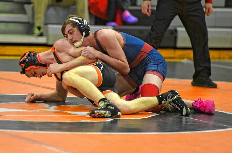 Mahar’s Elias Roberts (blue) takes down South Hadley’s Jackson Erali in the 138-pound match during the Senators’ 54-29 win over the Tigers on Tuesday night in South Hadley.