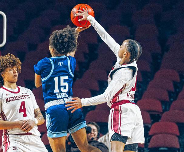 UMass guard Yahmani McKayle (10) blocks a shot while forward Lilly Ferguson (4) takes a charge during the first half of the Minutewomen’s 42-40 loss to Rhode Island on Sunday afternoon in Amherst.