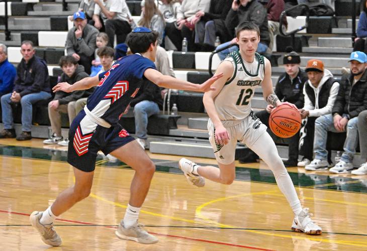 Greenfield’s Caleb Thomas drives to the rim against Maimonides  during a preliminary round contest of the MIAA Div. 4 state tournament on Tuesday at Nichols Gymnasium.  