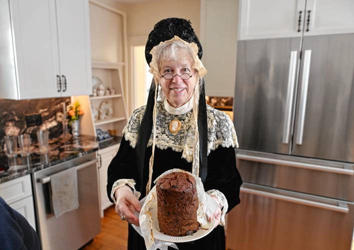 Eliza Baylies Wheaton, played by Zephorene Helmreich, with a traditional dessert called Deacon Porter’s Hat at a celebratory luncheon in Shelburne Falls to mark the birthday of the late Mary Lyon.