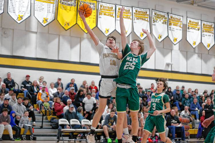 Pioneer’s Brayden Thayer (10) drives the ball to the hoop against Ware defender Justin Grout (25) in the third quarter of their MIAA Division 5 quarterfinal.