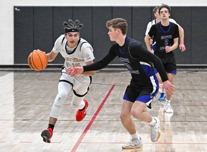 Pioneer’s Alex McClelland is defended by Smith Academy’s Jake Wilcox during the top-seeded Panthers’ victory in the Western Mass. Class D semifinal round at Messer Gymnasium in Northfield Wednesday. 