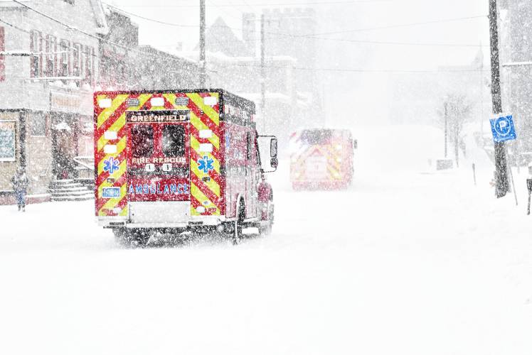 Members of the Greenfield Fire Department head up Hope Street responding to a medical call in the middle of Sunday’s snowstorm.