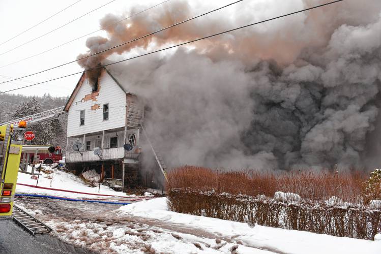 Thick black smoke flows from a fire at 117 Readsboro Road in Monroe on Wednesday. 
