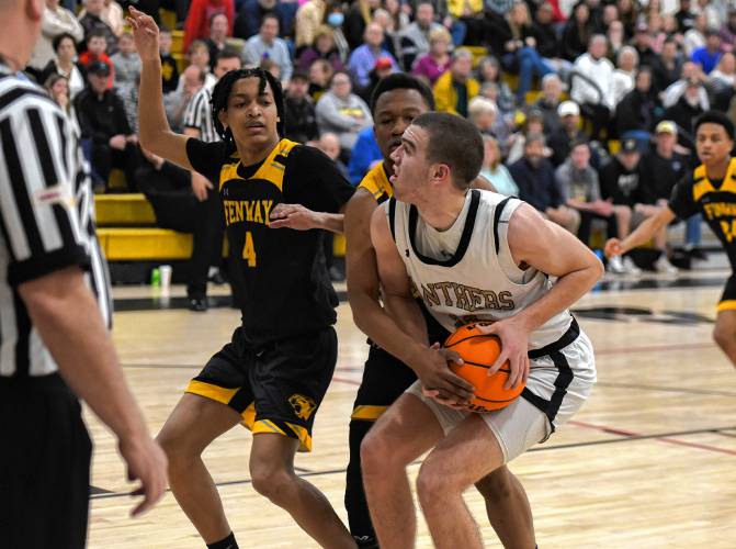 Pioneer’s Josh Wood (32) ties to get past a pair of defenders during the Panthers’ 65-37 win over Fenway in the MIAA Division 5 Round of 32 on Friday night at Messer Gymnasium in Northfield.
