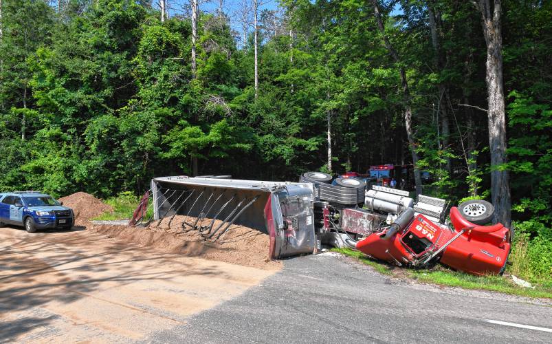 A tractor-trailer truck hauling a load of dirt crashed at the base of Prescott Road in Shutesbury on Monday morning, dumping part of the load onto Daniel Shays Highway (Route 202). According to officers on scene, the driver reportedly escaped any serious injuries, but the trailer blocked Prescott Road completely, rerouting traffic in Shutesbury Center.