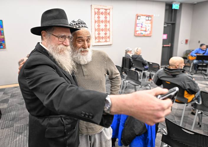 Two friends take a selfie at a Hanukkah potato pancake social at the Greenfield Public Library on Monday evening.