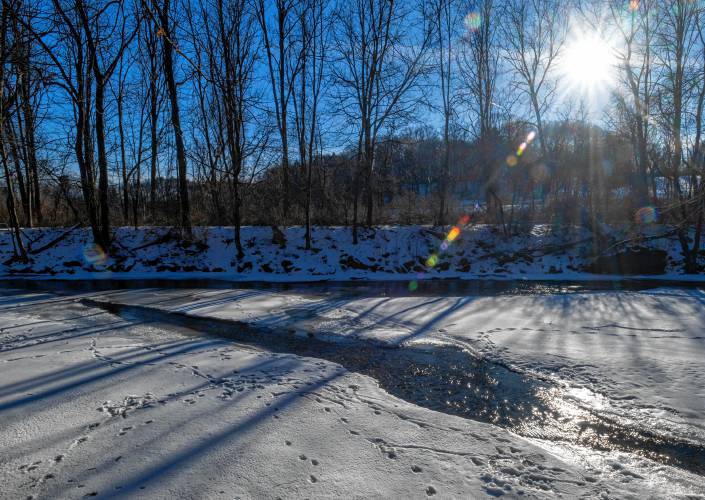 Tracks are left in the snow at the Mill River in Northampton. A goldendoodle fell through the ice on the river earlier this month and could not be recovered.
