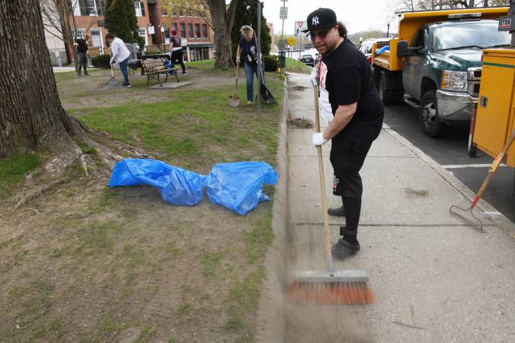 Volunteer Robert Lozada of Greenfield cleans up the Greenfield Common.