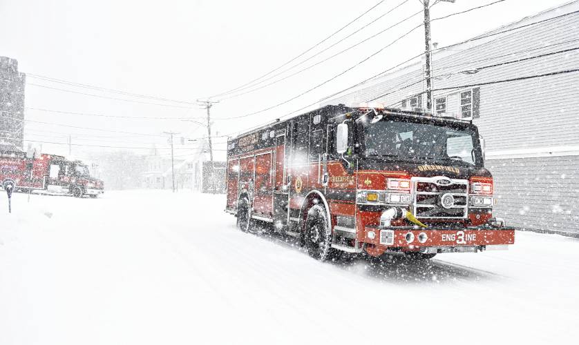 Members of the Greenfield Fire Department head up Hope Street responding to a medical call in the middle of Sunday’s snowstorm.
