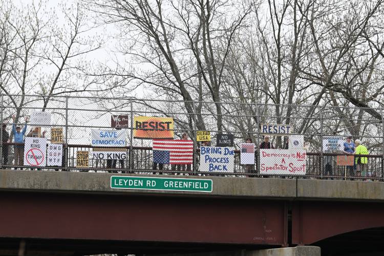 Protesters gather on the Leyden Road overpass of Interstate 91 in Greenfield on Friday afternoon. According to an announcement from Franklin County Continuing the Political Revolution member David Greenberg, the “Overpass Day” aimed to “raise awareness about the multiple attacks on our society and our democracy by the Trump administration.”