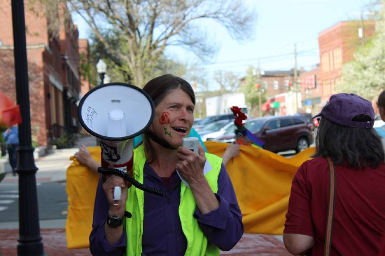 Montague Resists organizer Laurie Davidson leads the group during a parade up Avenue A in Turners Falls on Thursday for the “International Labor Day Bread and Roses Parade and Rally.”
