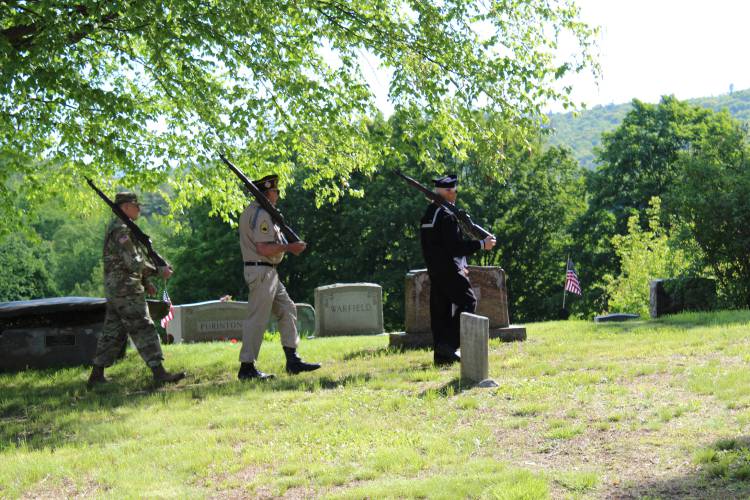 Veterans Jason Jarvis, Robert March and Greg Zagrobski prepare to fire their rifles in a salute to fallen U.S. military members.