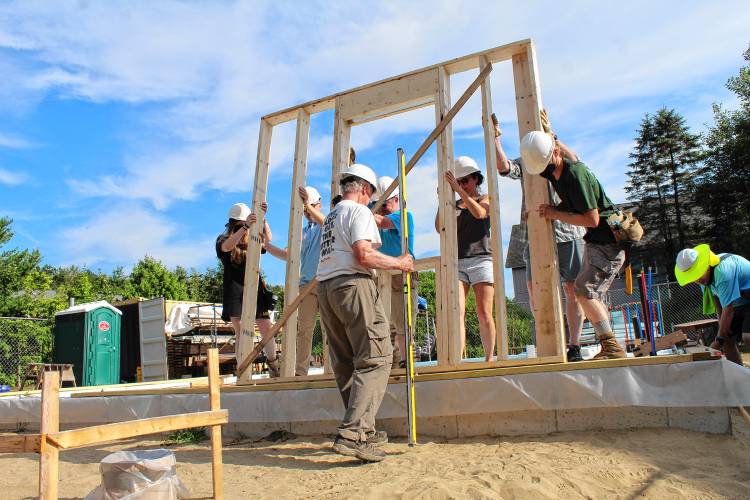Volunteers lift the first wall of Pioneer Valley Habitat for Humanity’s 184 Petty Plain Road affordable house in Greenfield on Sunday.