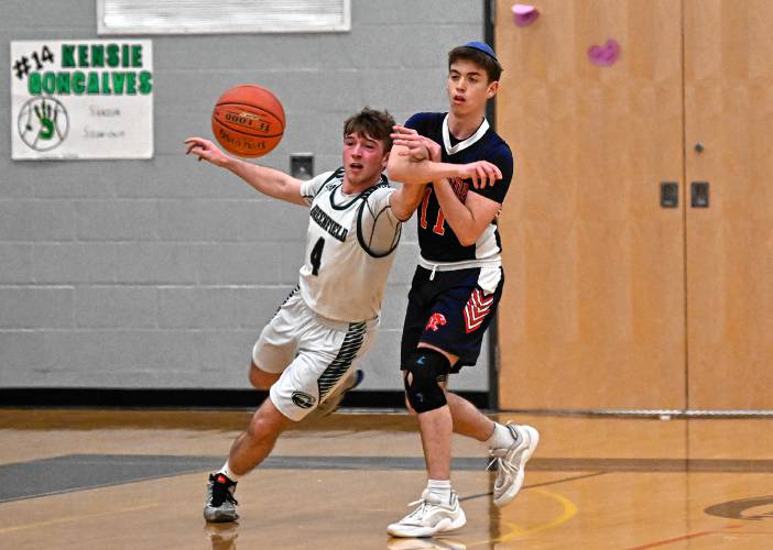 Greenfield’s Caleb Murray pokes the ball away from Maimonides’ Daniel Ziber  during a preliminary round contest of the MIAA Div. 4 state tournament on Tuesday at Nichols Gymnasium. 