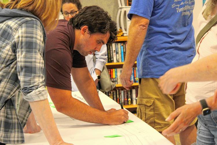 Green International Affiliates Project Manager Nick Millhollin writes down feedback from community members about the proposed Route 2 redesigns at the Erving Senior & Community Center on Wednesday.