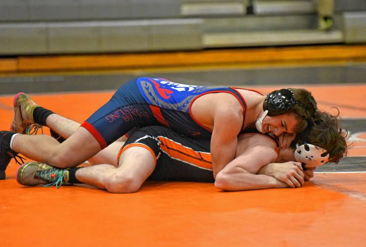 Mahar’s Joshua Mazza positions himself on top of South Hadley’s Will Drew in the 144-pound match during the Senators’ 54-29 win over the Tigers on Tuesday night in South Hadley.