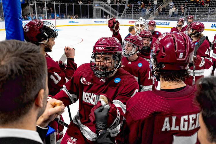 The UMass team celebrates its 5-4 overtime victory over Minnesota in Fargo, N.D. on Thursday night. 