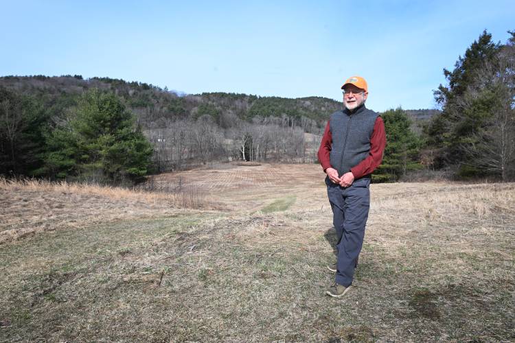 Jack Lochhead stands atop a hill in his 65 acres of land bordering Reeds Bridge Road and the South River in Conway. The land is being conserved with help from the Franklin Land Trust.
