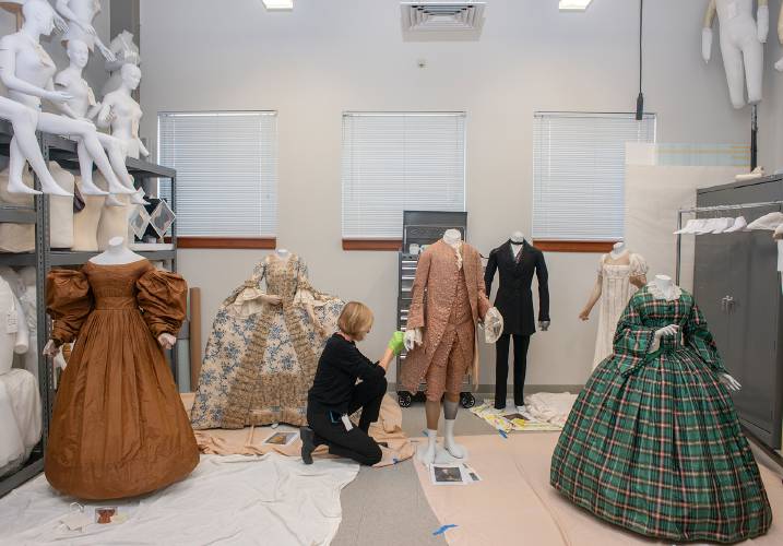 Lauren Whitley, Historic Deerfield’s curator of textiles and clothing, dressing mannequins for “Body by Design” in the textile workroom. The show opens on May 3.